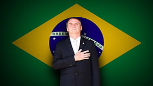 Jair Bolsonaro Standing Before Brazilian Flag in Formal Suit HD wallpaper