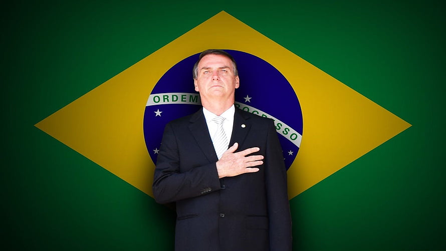 Jair Bolsonaro Standing Before Brazilian Flag in Formal Suit HD wallpaper