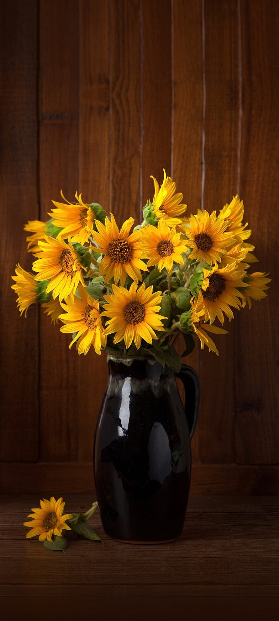 Vibrant Sunflower Bouquet in a Dark Ceramic Pitcher on a Rustic Wooden Background HD phone wallpaper