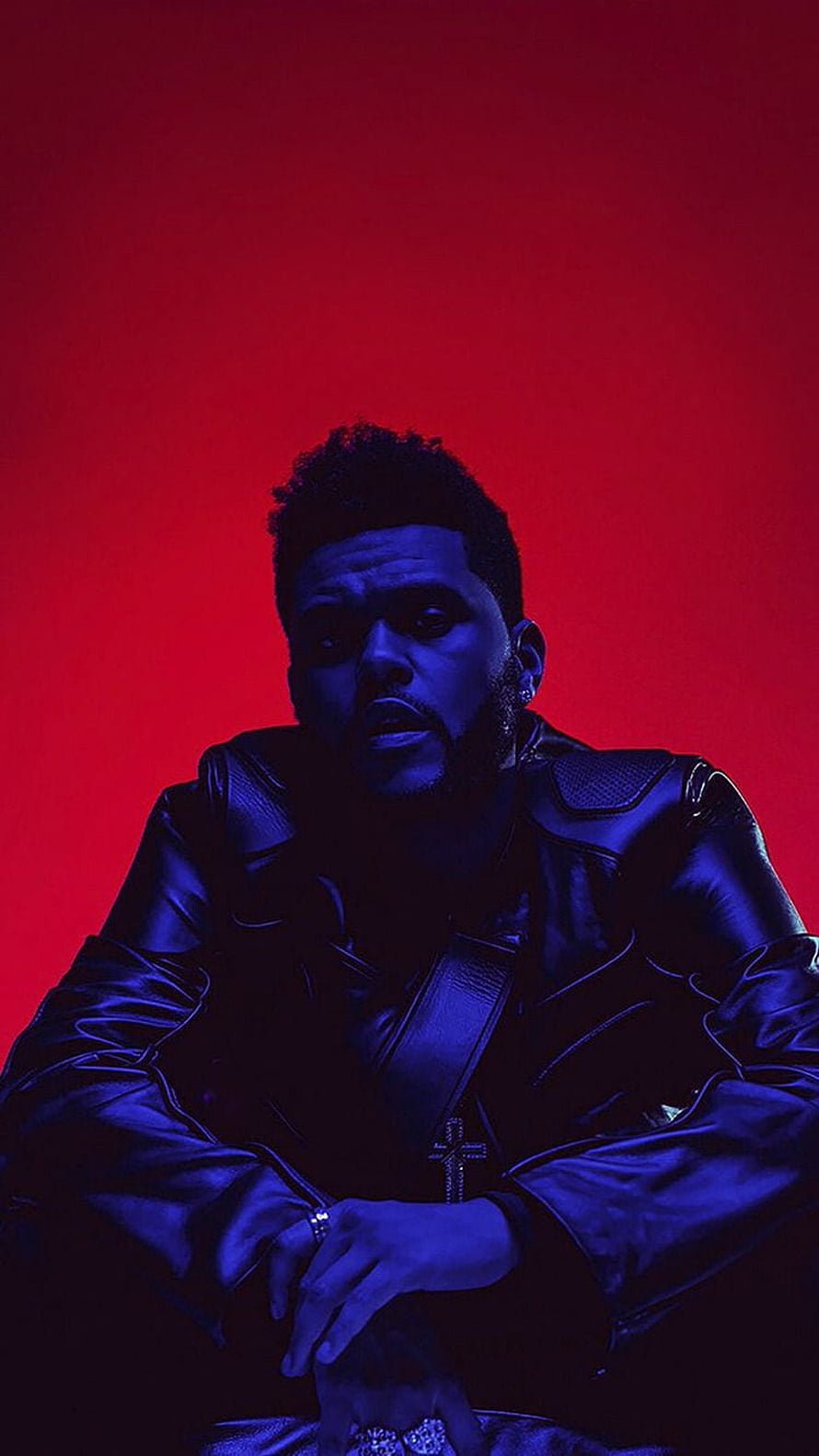 The Weeknd in a black leather jacket with a cross pendant against a vivid red background HD phone wallpaper