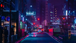 Neon-lit Japanese city street at night with wet asphalt reflecting vibrant blue and purple lights HD wallpaper