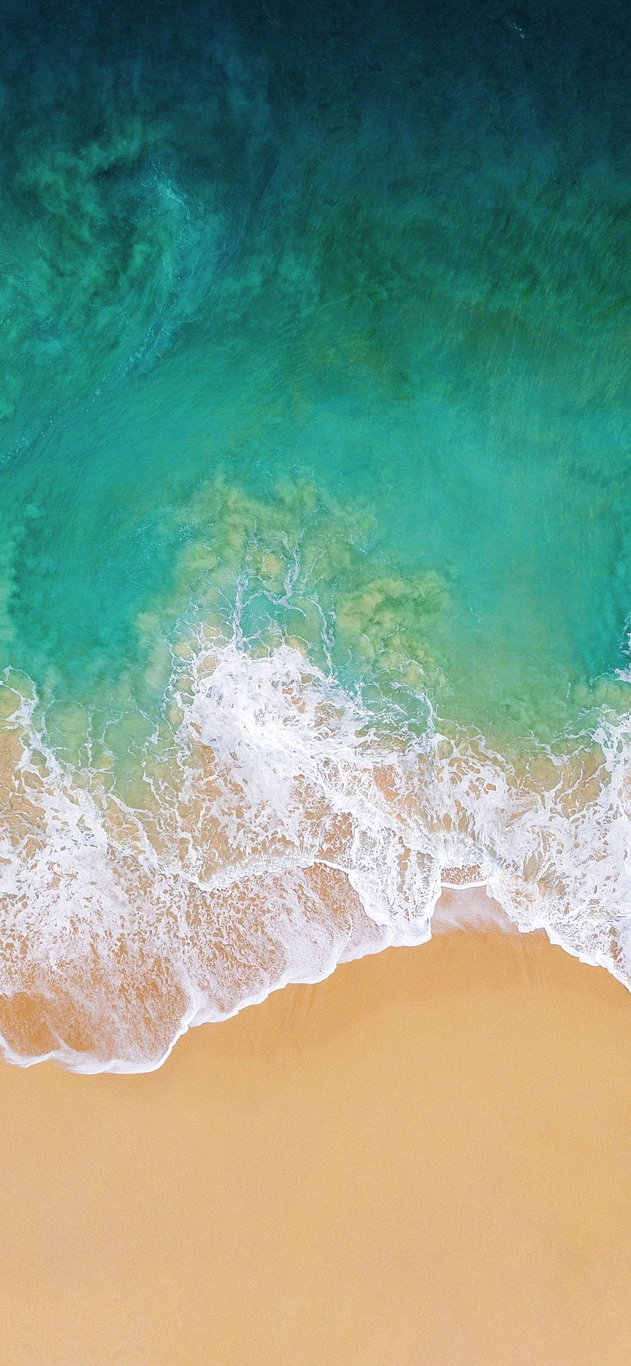 Aerial View of Turquoise Ocean Waves Rolling onto Golden Sandy Beach HD phone wallpaper