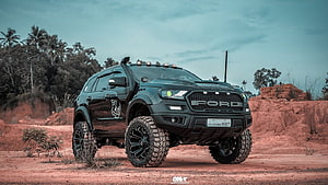 Black Ford Endeavour SUV with Off-Road Tires in Red Desert Terrain HD wallpaper