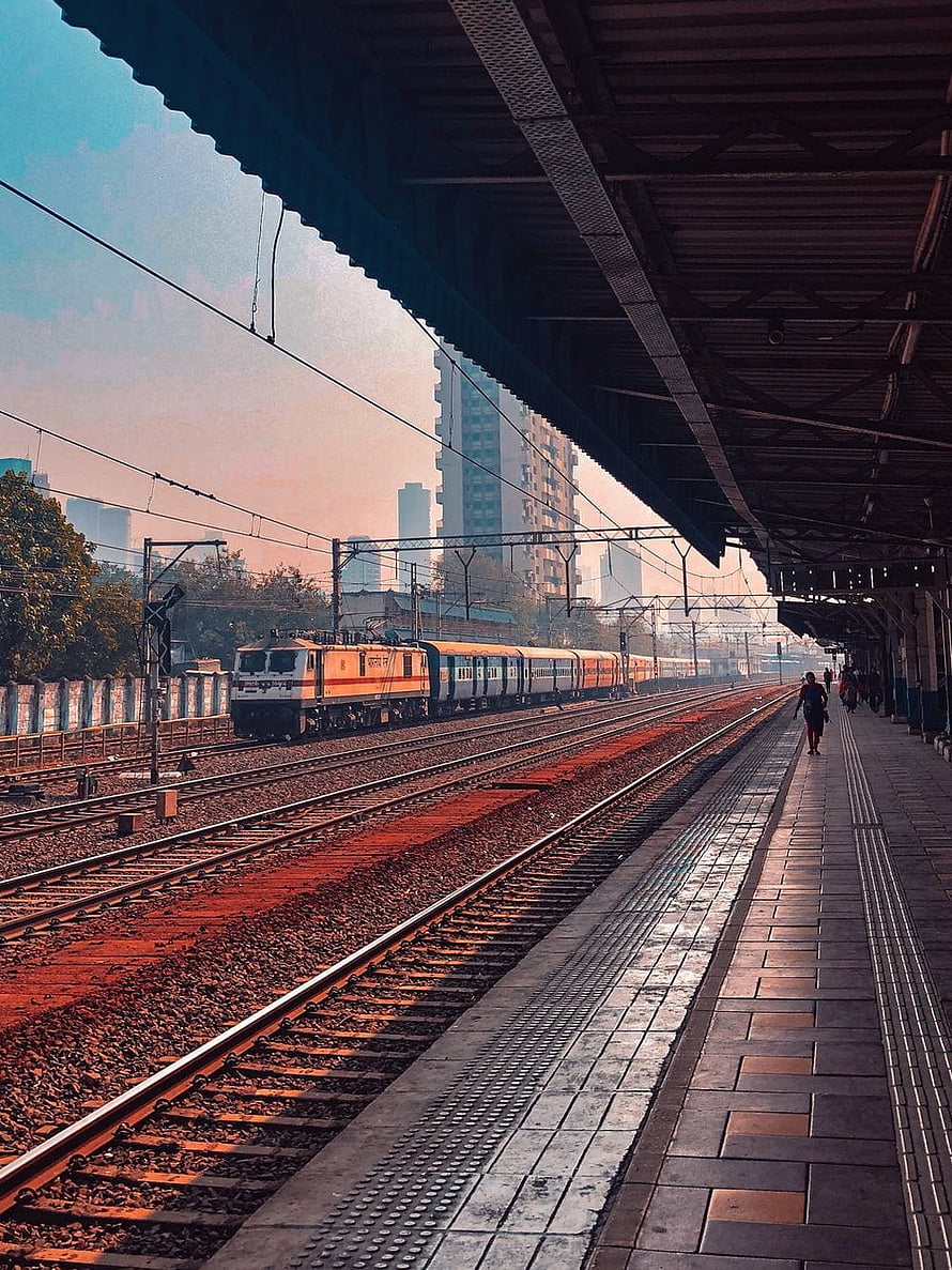 Indian Railway Train Arriving at a City Station Platform at Dusk HD phone wallpaper