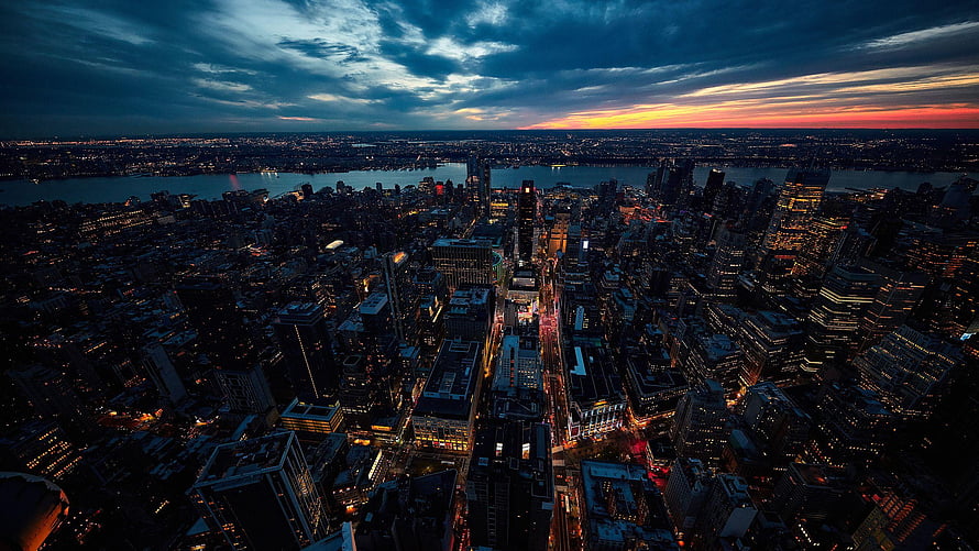 Aerial View of New York City Skyline at Dusk with Dramatic Sunset Horizon HD wallpaper