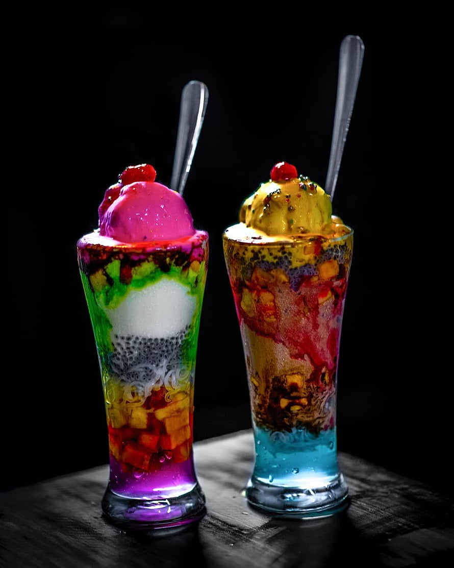 Vibrant layered faluda dessert drinks with ice cream and fruit in tall glasses HD phone wallpaper
