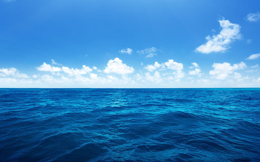 Calm Ocean Horizon Under a Bright Blue Sky with Scattered Clouds HD wallpaper