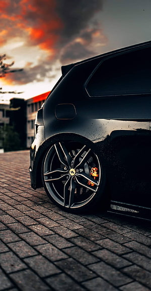 Low Rides Black SUV with Custom Alloy Wheels and Orange Brakes at Sunset HD phone wallpaper