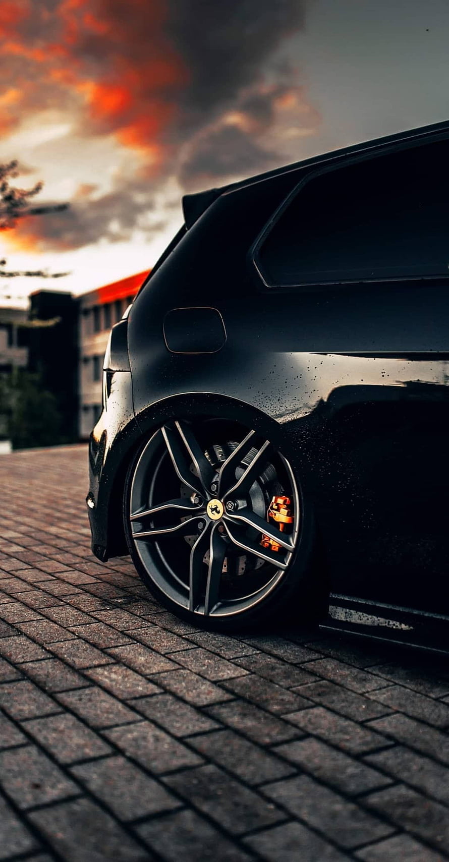 Low Rides Black SUV with Custom Alloy Wheels and Orange Brakes at Sunset HD phone wallpaper