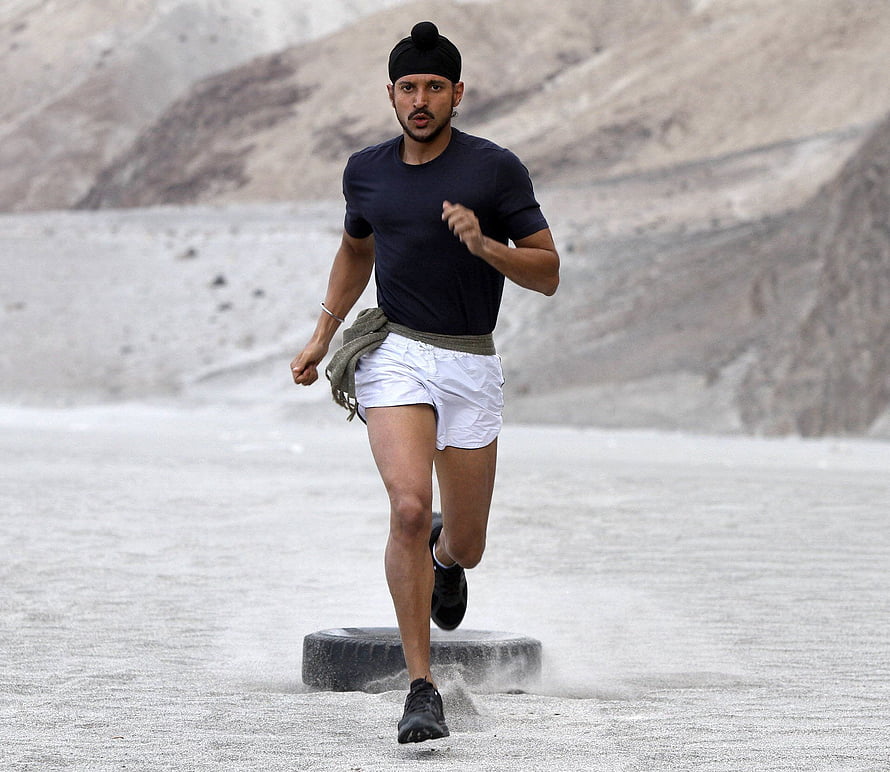 Farhan Akhtar as Milkha Singh sprinting across a dusty desert track in Bhaag Milkha Bhaag HD wallpaper