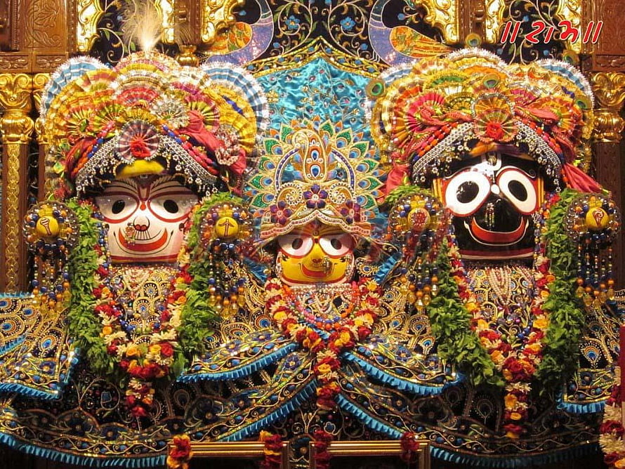 Colorful idols of Lakshmi Narayan and Gopal adorned with flowers and jewelry in a temple setting HD wallpaper