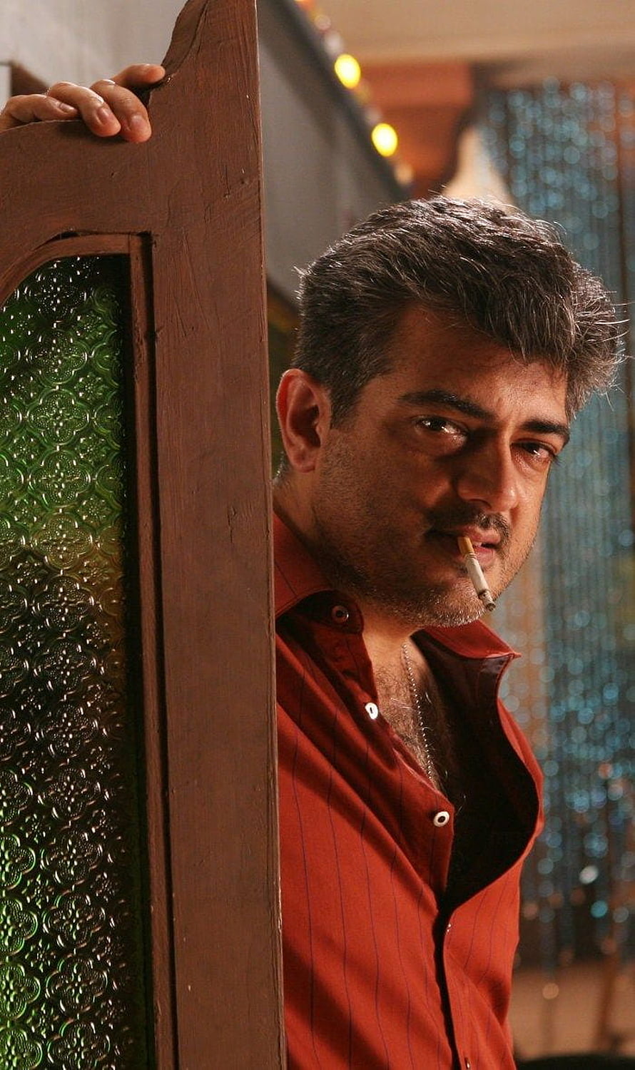 Ajith Kumar in Mankatha wearing a red shirt and smoking a cigarette HD phone wallpaper