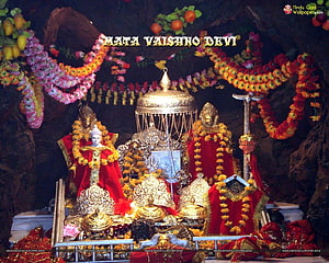 Mata Vaishno Devi shrine adorned with vibrant marigold garlands and golden ornaments HD wallpaper