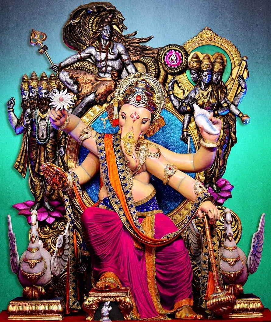 Vibrant Ganesha Statue with Shiva and Parvati Background HD phone wallpaper