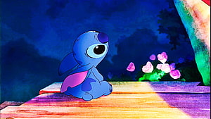 Stitch from Lilo and Stitch Sitting on a Wooden Deck at Night with Pink Flowers HD wallpaper