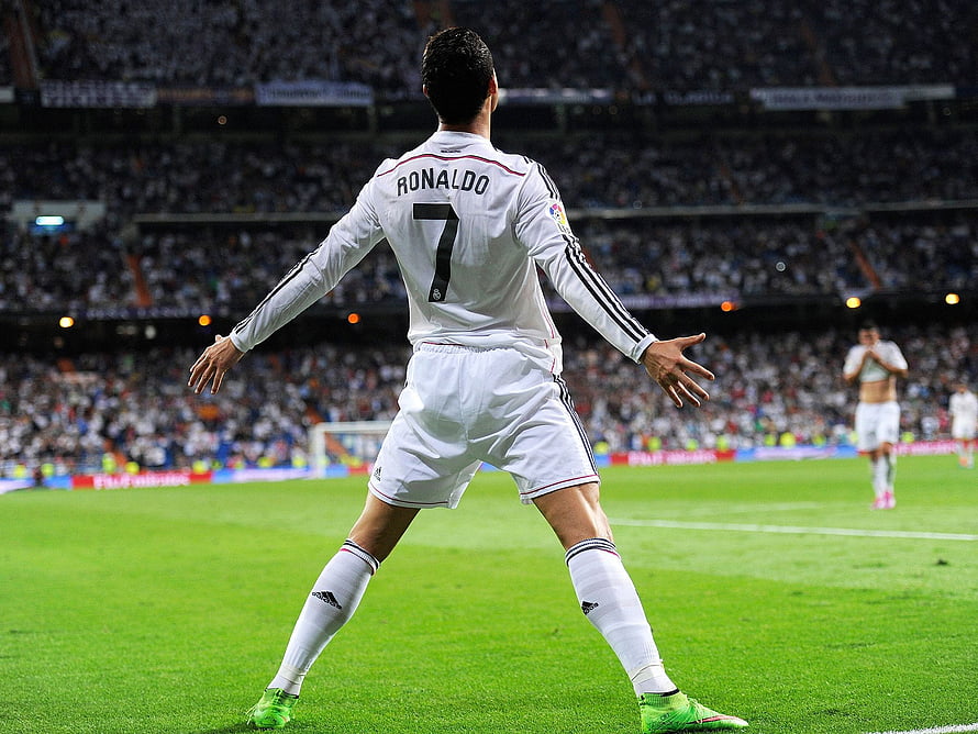 Cristiano Ronaldo in Real Madrid White Kit Celebrating on the Pitch with Arms Outstretched HD wallpaper