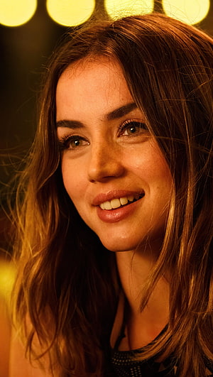 Anna De Armas smiling portrait with warm golden bokeh lights background HD phone wallpaper