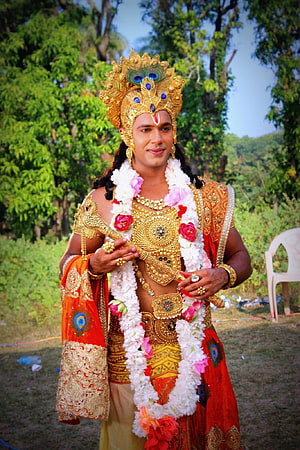 Saurabh Pandey as Lord Krishna in ornate golden crown and traditional red costume HD phone wallpaper
