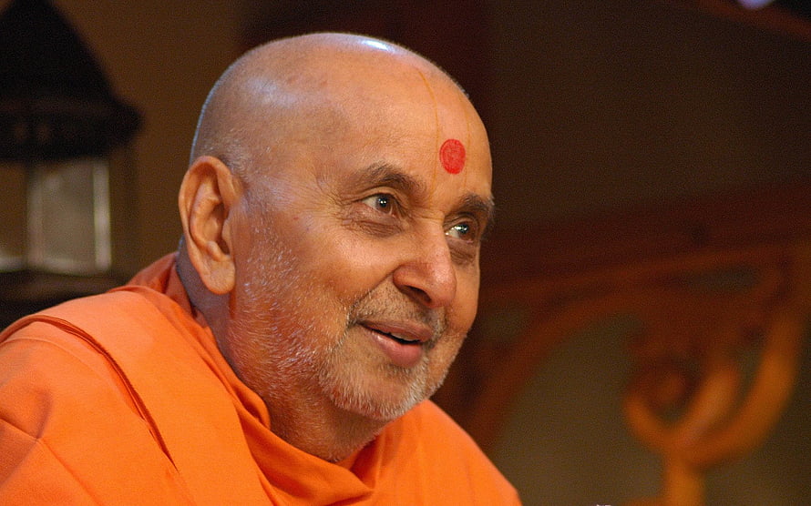 Baps Pramukh Swami Maharaj in traditional orange robes with tilak HD wallpaper