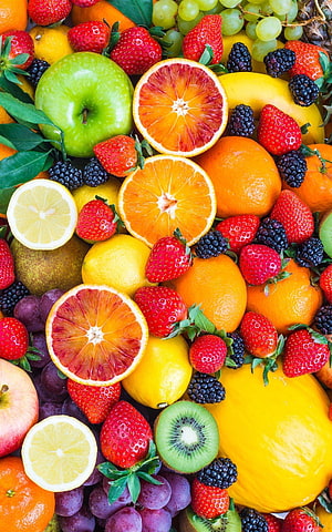 Vibrant Fresh Fruit Arrangement with Citrus, Berries, and Tropical Slices HD phone wallpaper