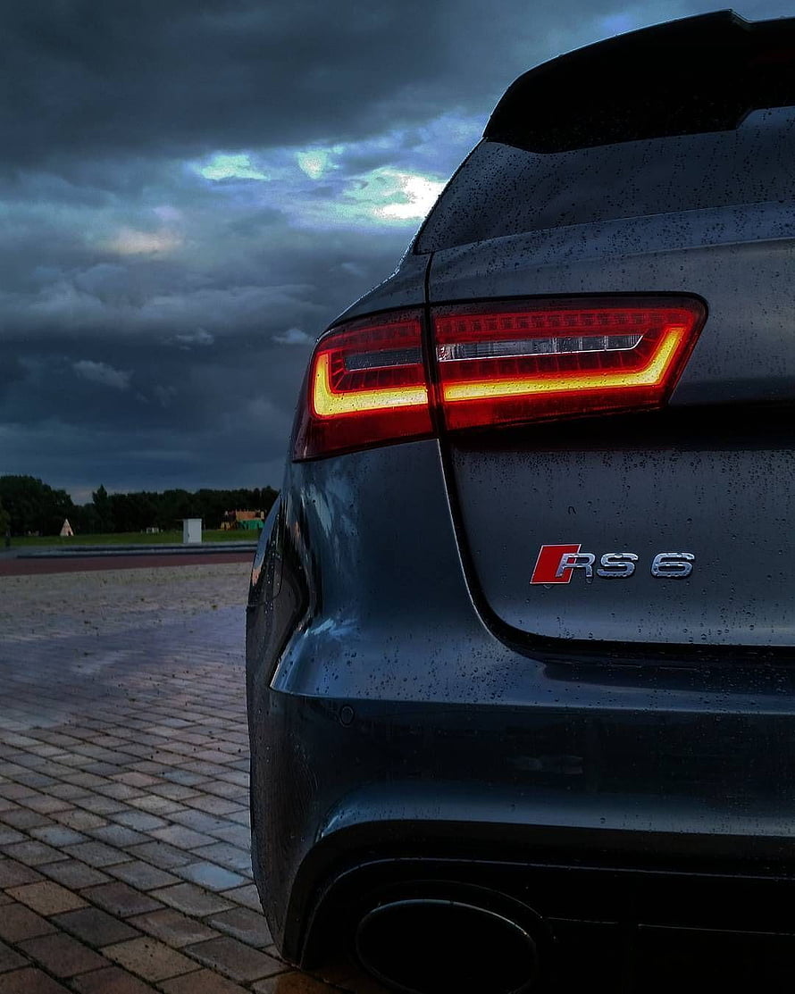 Audi RS 6 Rear Taillight Detail Under Dramatic Stormy Sky HD phone wallpaper