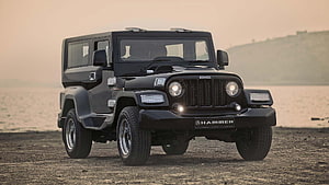Mahindra Thar Black Off-Road SUV Parked on Gravel Shore at Sunset HD wallpaper