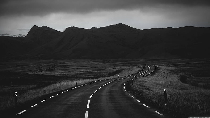 Monochrome Highway Winding Through Dramatic Mountain Landscape HD wallpaper