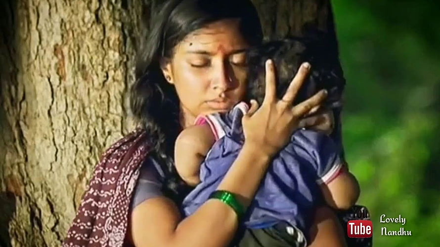 KGF Mother Embracing Child Against Tree Trunk in Emotional Scene HD wallpaper