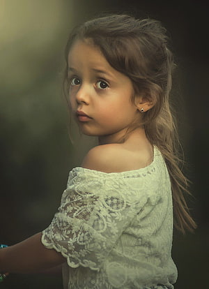 Portrait of a young girl in a white lace top with a soft, contemplative expression HD phone wallpaper