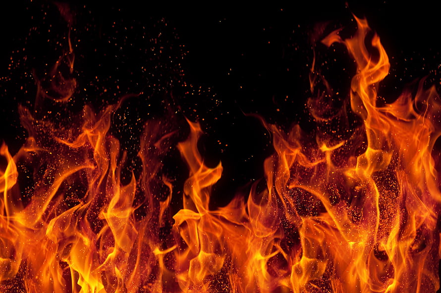 Intense Orange Flames and Glowing Embers Rising Against a Dark Background HD wallpaper