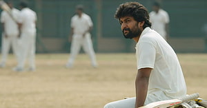 Jersey Movie Still: Bearded Cricketer in White Kit on Dusty Pitch HD wallpaper