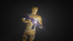 Counter-Strike 2 Player Character Wrapped in Yellow Bandages Holding Neon AK-47 HD wallpaper