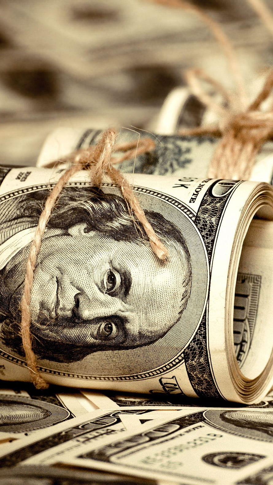 Rolled US Dollar Bills Tied with Twine on a Stack of Cash HD phone wallpaper