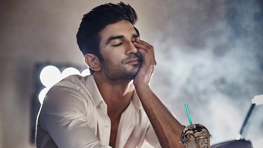 Sushant Singh Rajput in a white shirt with a thoughtful expression and iced coffee HD wallpaper