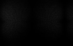 Minimalist Dark Black Fabric Texture Background with Subtle Vignette and Grainy Surface Detail HD wallpaper