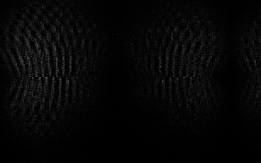 Minimalist Dark Black Fabric Texture Background with Subtle Vignette and Grainy Surface Detail HD wallpaper