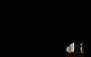 Linux Tux Penguin Sitting at Desk with Old CRT Monitor in Dark Room HD wallpaper
