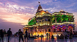 Prem Mandir Temple in Vrindavan Illuminated at Dusk with Colorful Lights and Visitors HD wallpaper