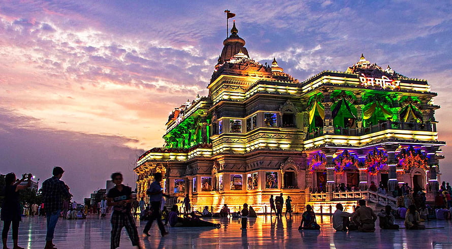 Prem Mandir Temple in Vrindavan Illuminated at Dusk with Colorful Lights and Visitors HD wallpaper