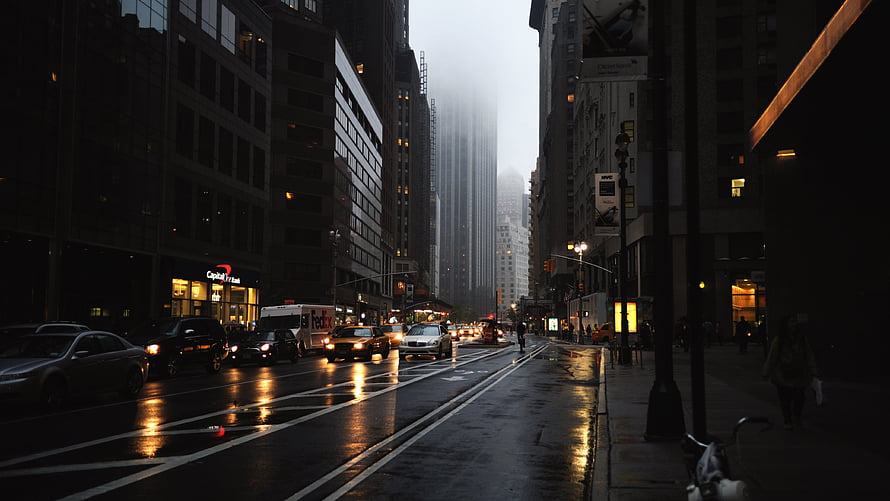 Moody Wet Street Scene in New York City with Traffic and Skyscrapers HD wallpaper