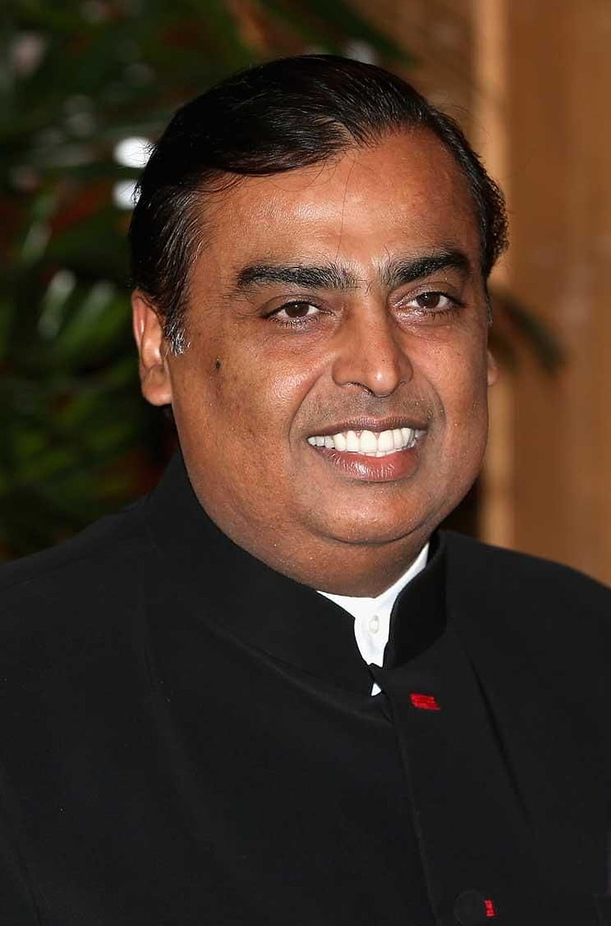 Mukesh Ambani in a black bandhgala jacket with a warm smile and formal portrait HD phone wallpaper
