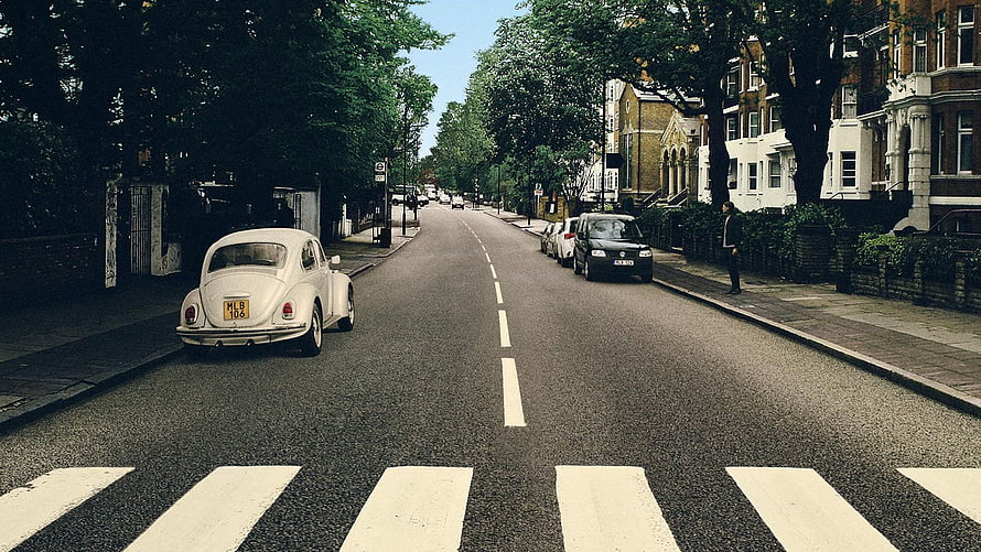 Classic White Volkswagen Beetle Parked on a Tree-Lined London Street HD wallpaper