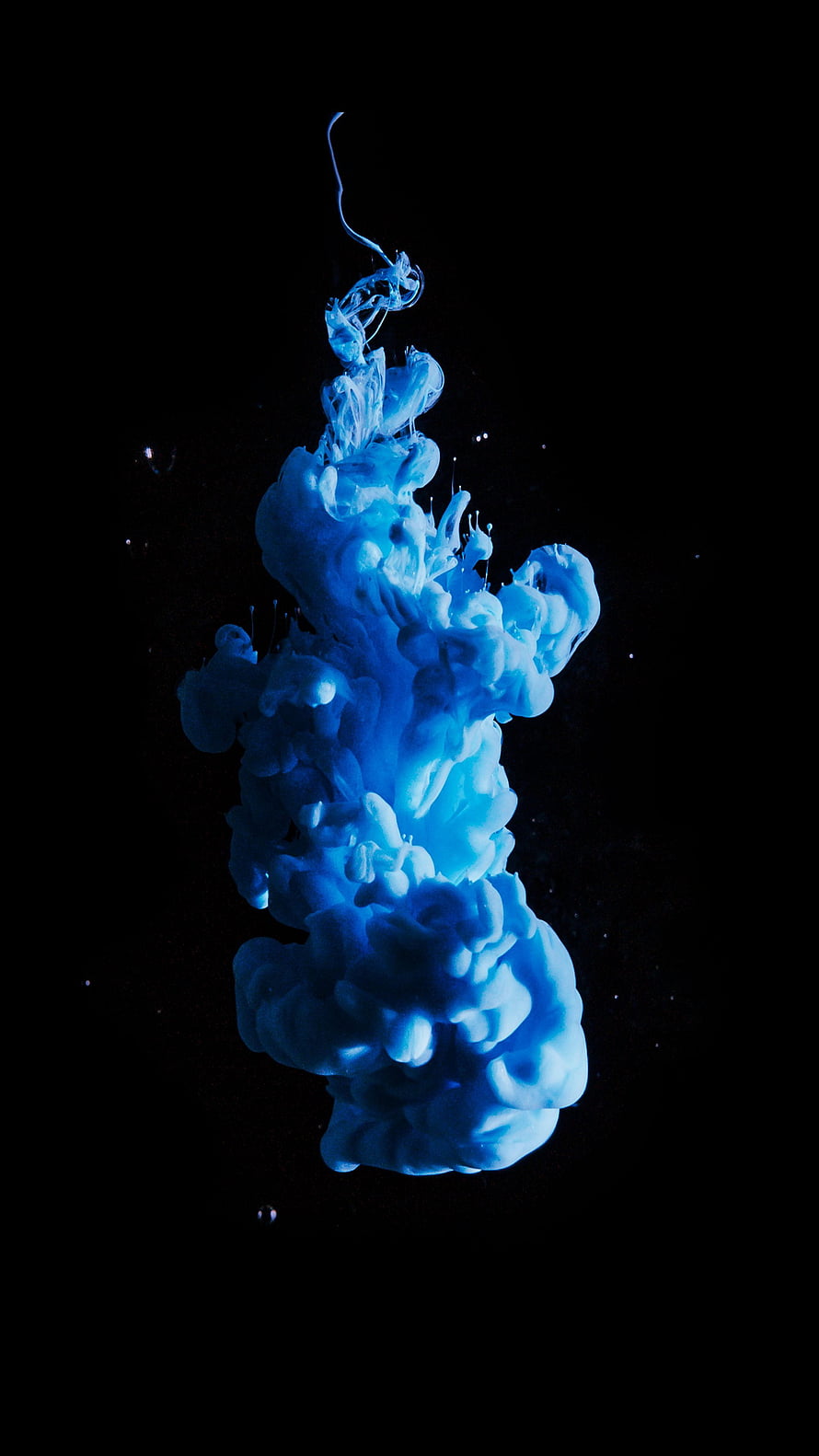 Abstract Blue Ink Cloud Rising in Water Against Black Background HD phone wallpaper
