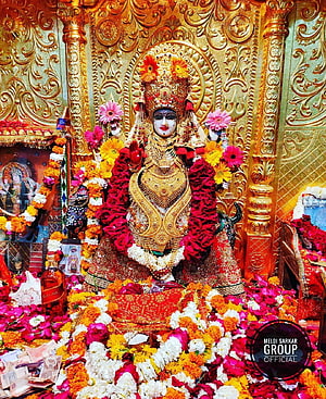Ornate Hindu Goddess Statue Adorned with Flowers and Gold Jewelry in Temple HD phone wallpaper