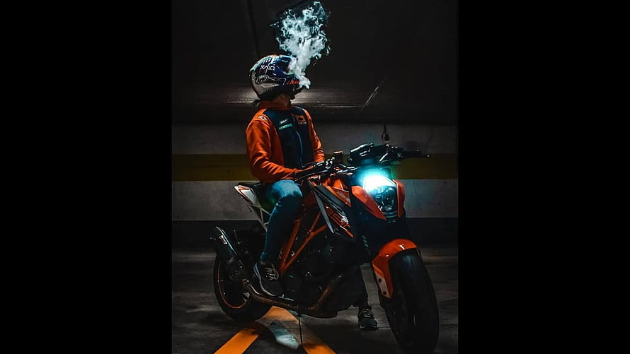 Rider on Orange KTM Duke Motorcycle in Dark Underground Parking Garage HD wallpaper