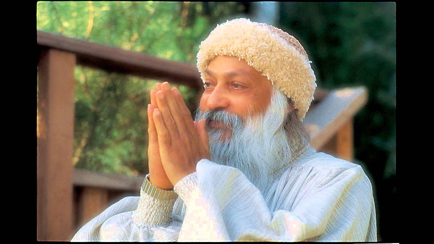 Osho in White Robes and Fur Cap with Hands in Prayer Pose HD wallpaper