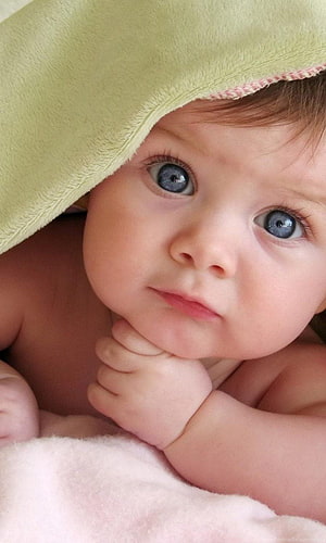 Adorable Baby Boy With Blue Eyes Peeking From Under A Soft Green Blanket HD phone wallpaper
