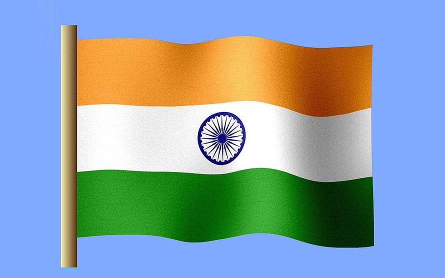 Indian National Flag Waving on a Pole Against a Clear Blue Sky HD wallpaper