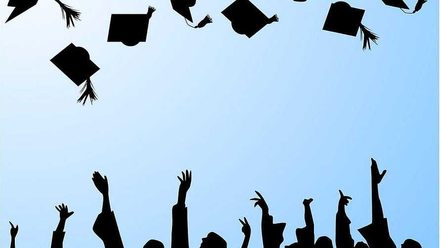 Silhouetted Graduates Tossing Caps Against a Clear Blue Sky HD wallpaper