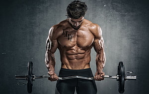 Muscular Male Bodybuilder Performing Barbell Curl With Defined Abs and Chest HD wallpaper